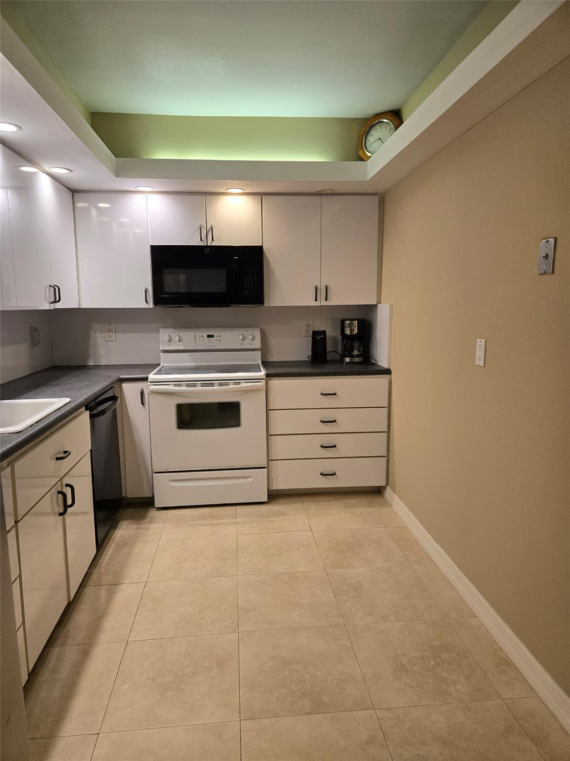 2851 South Ocean Boulevard, Unit 6D Boca Raton, FL 33432 - Photo 12 of 34 a kitchen with stainless steel appliances granite countertop a stove top oven a sink and a refrigerator
