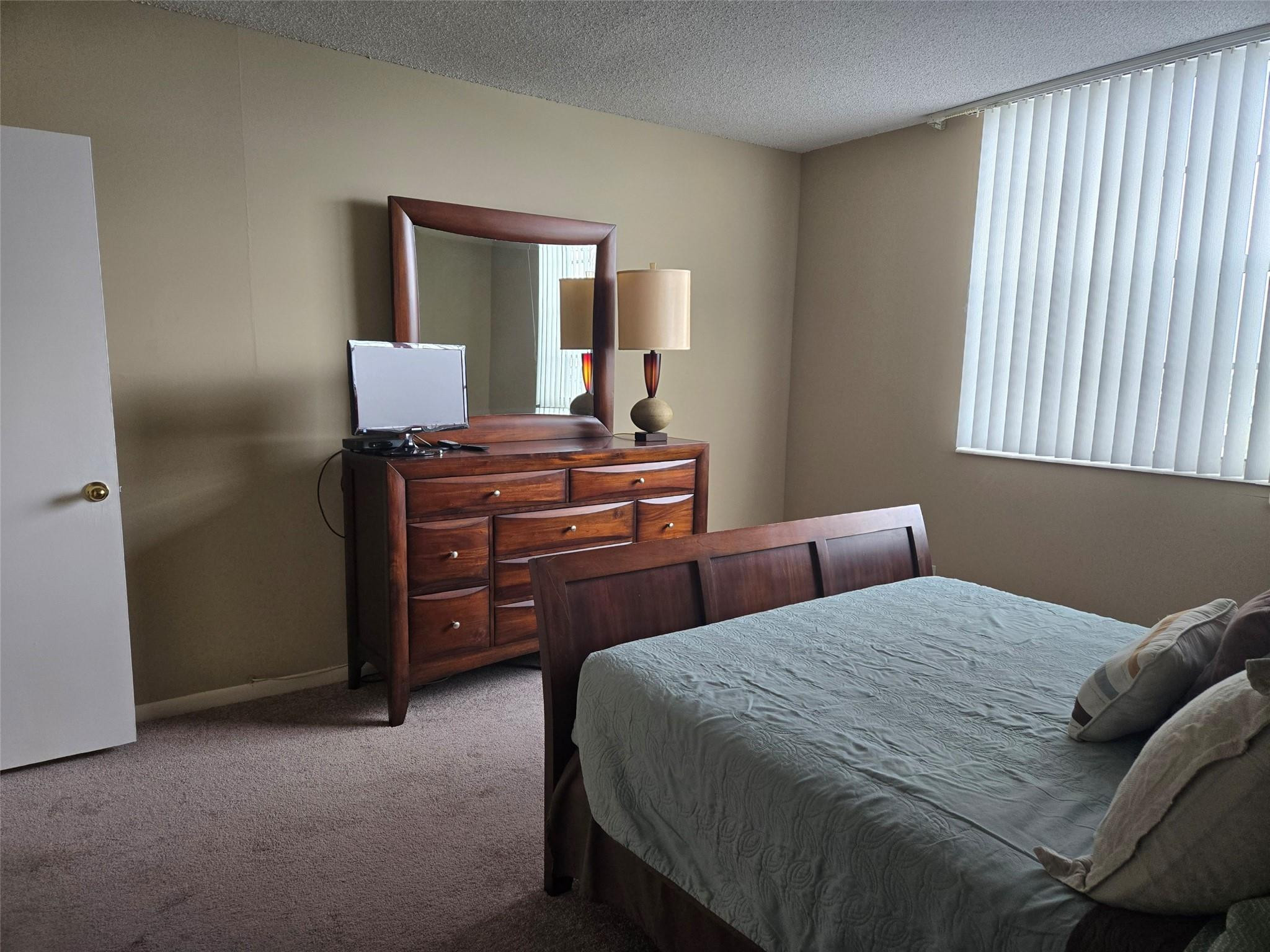 2851 South Ocean Boulevard, Unit 6D Boca Raton, FL 33432 - Photo 17 of 34 a bedroom with a bed and a dresser
