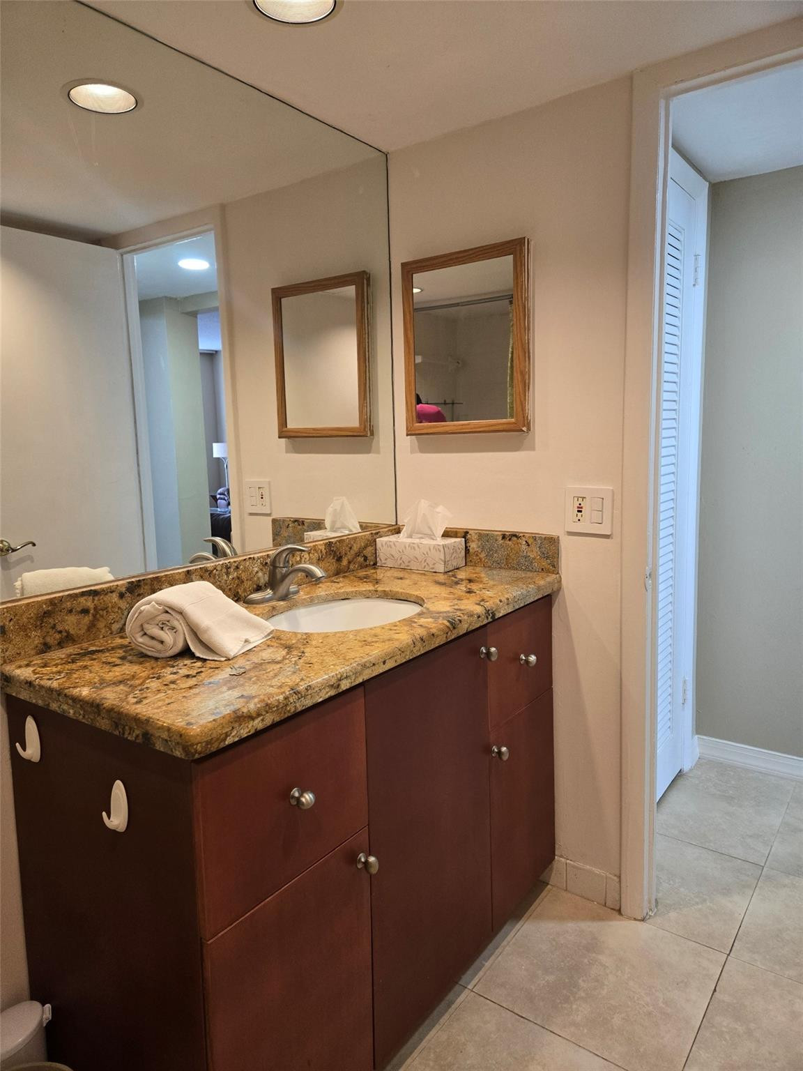2851 South Ocean Boulevard, Unit 6D Boca Raton, FL 33432 - Photo 22 of 34 a bathroom with a granite countertop sink and a mirror