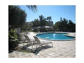 2851 South Ocean Boulevard, Unit 6D Boca Raton, FL 33432 - Photo 28 of 34 a view of a swimming pool with a patio