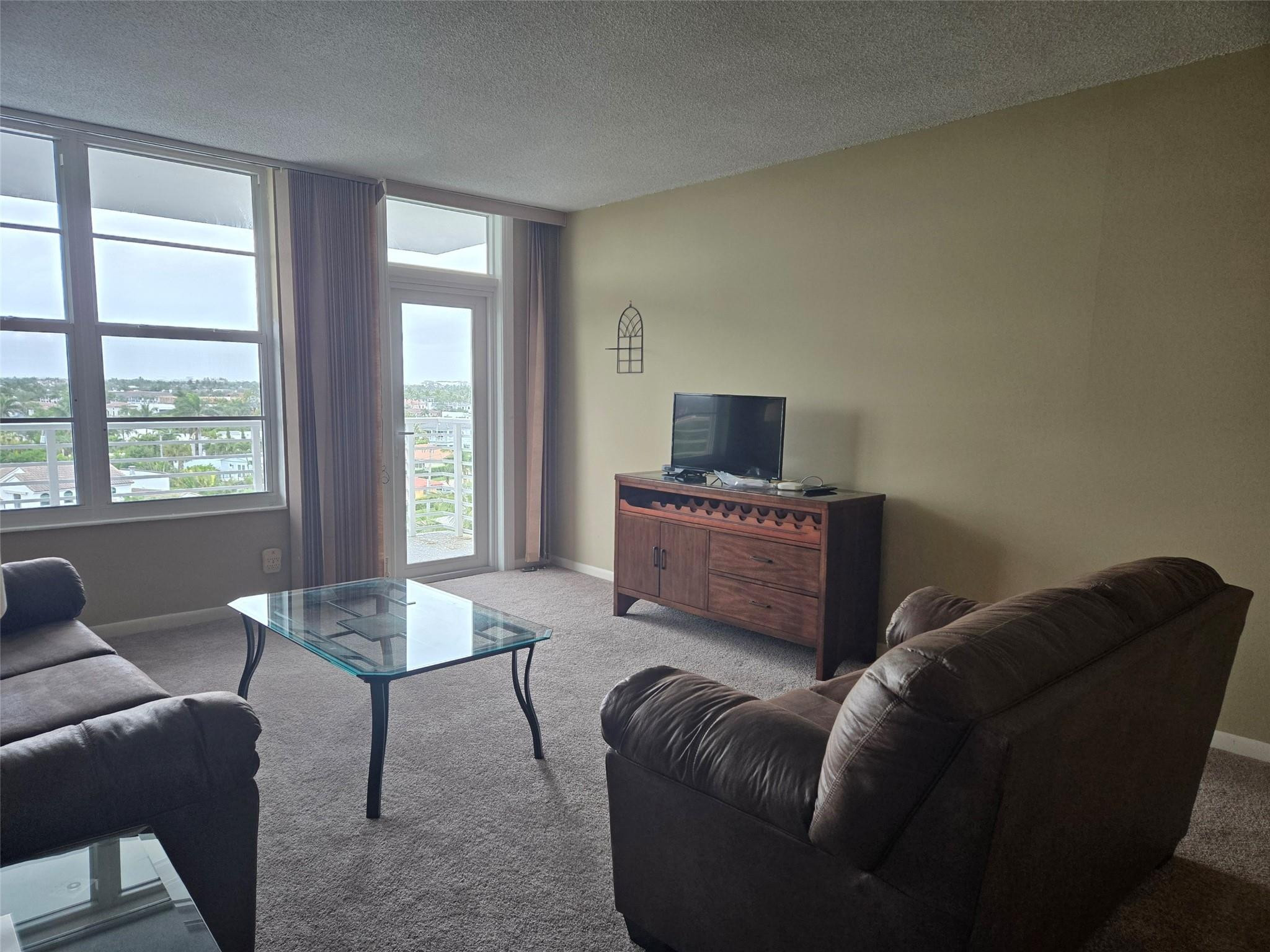 2851 South Ocean Boulevard, Unit 6D Boca Raton, FL 33432 - Photo 32 of 34 a living room with furniture and a flat screen tv