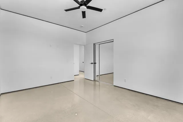 a view of a livingroom with a ceiling fan and window