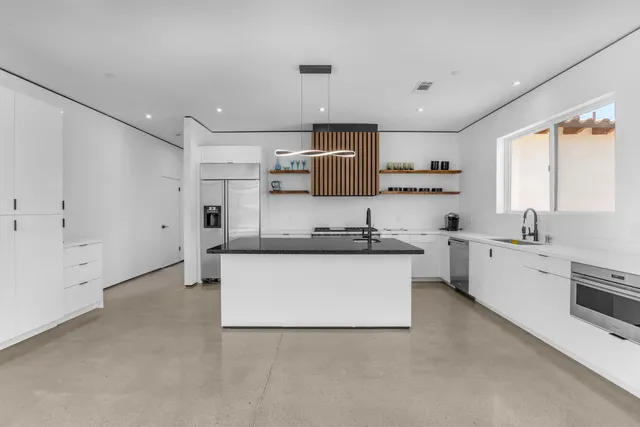 a kitchen with stainless steel appliances granite countertop a sink and cabinets