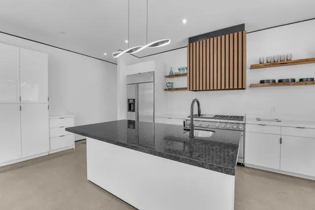 a kitchen with a sink a stove and a window