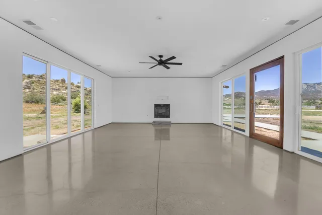 a view of a livingroom with a ceiling fan and window