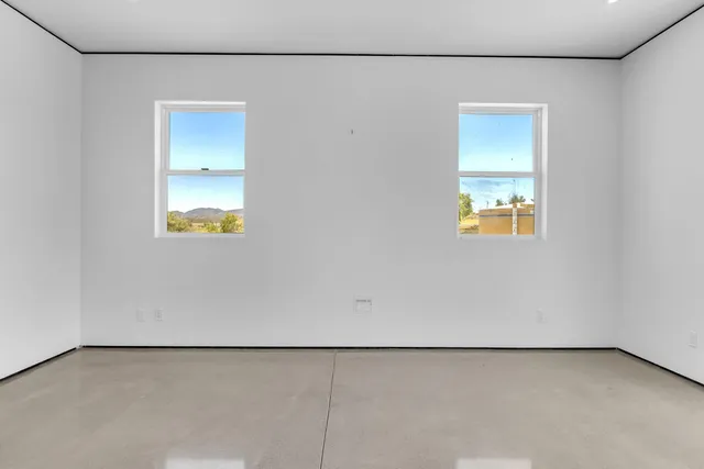 a view of a livingroom with a ceiling fan and wooden floor