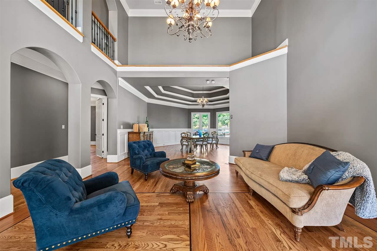 12515 Tuscan Lake Road Raleigh, NC 27613 - Photo 13 of 30 a living room with furniture and a chandelier