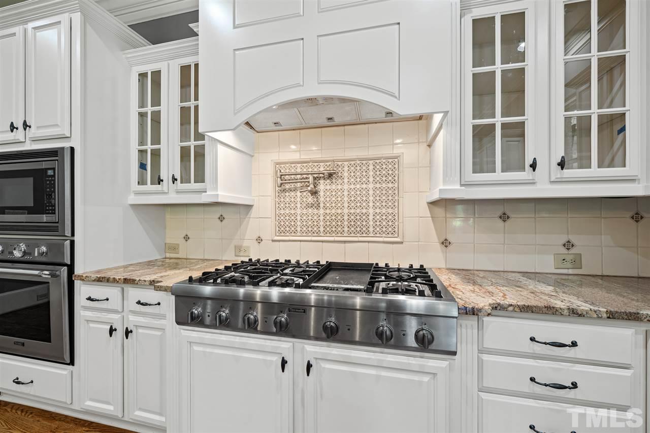 12515 Tuscan Lake Road Raleigh, NC 27613 - Photo 17 of 30 a kitchen with stainless steel appliances granite countertop a stove and a microwave