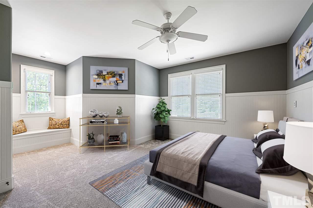 12515 Tuscan Lake Road Raleigh, NC 27613 - Photo 27 of 30 a bedroom with a large bed couch and a window