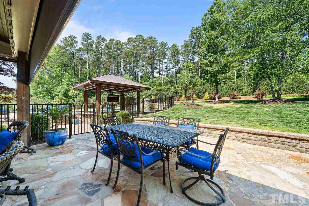 12515 Tuscan Lake Road Raleigh, NC 27613 - Photo 6 of 30 a view of backyard with seating space and trees