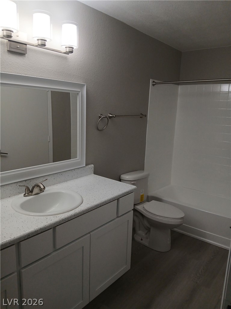 555 East Silverado Ranch Boulevard, Unit 1098 Las Vegas, NV 89183 - Photo 4 of 10 A well-appointed bathroom with durable laminate flooring and a modern vanity, ready for daily routines.