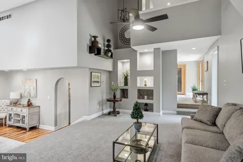 a open kitchen with white cabinets and wooden floor