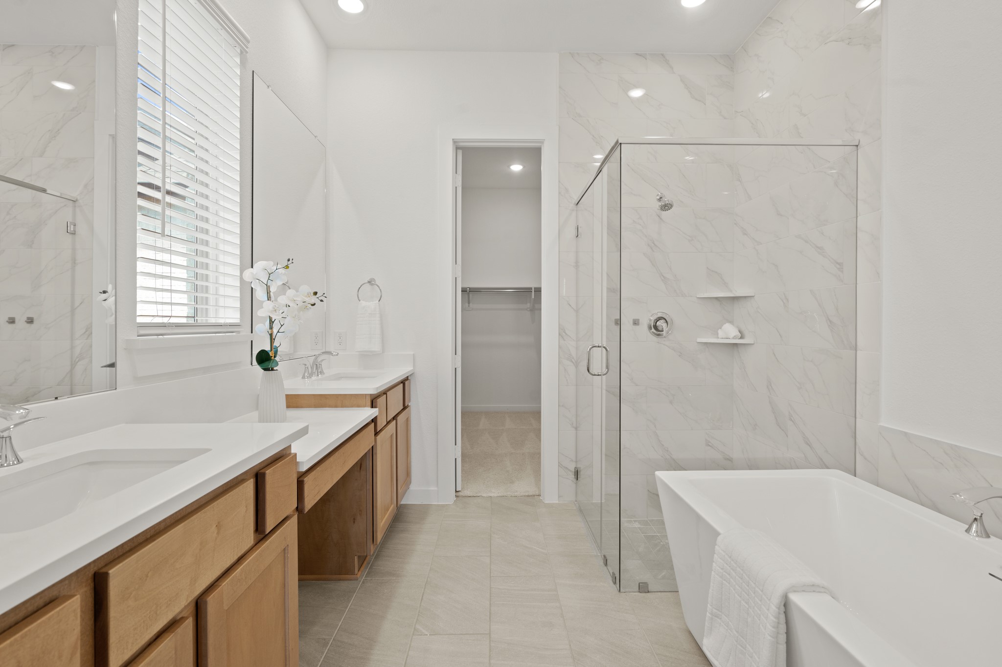 7303 Compass Drive Katy, TX 77493 - Photo 17 of 31 a bathroom with a tub sink and mirror