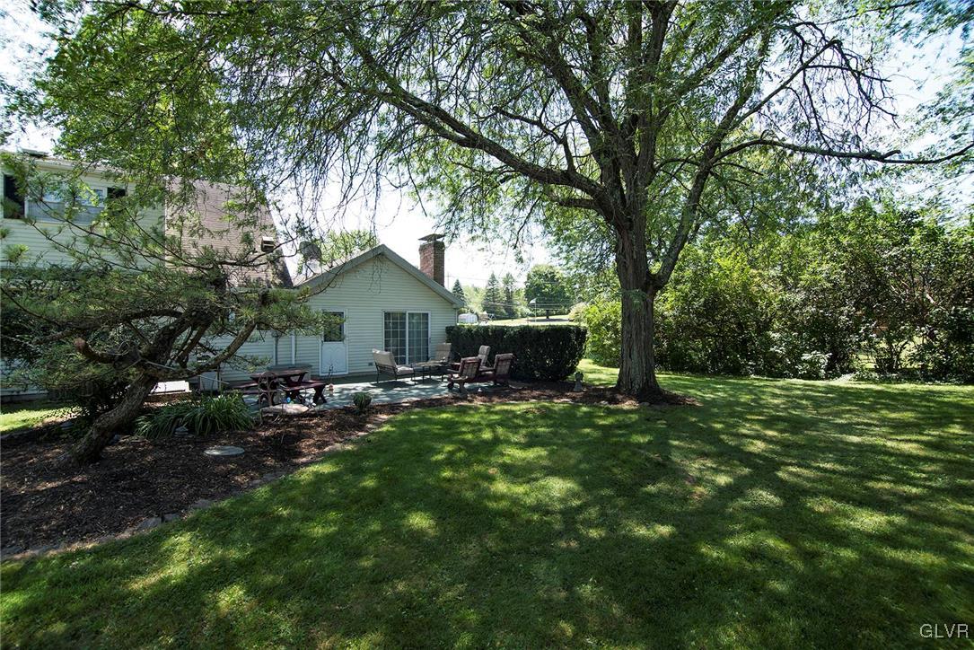 650 Williams Road Nazareth, PA 18064 - Photo 4 of 44 a view of backyard with wooden fence and a large tree