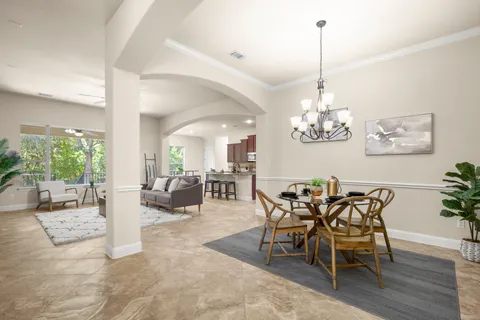 a living room with furniture and kitchen view