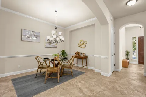 a living room with furniture and kitchen view