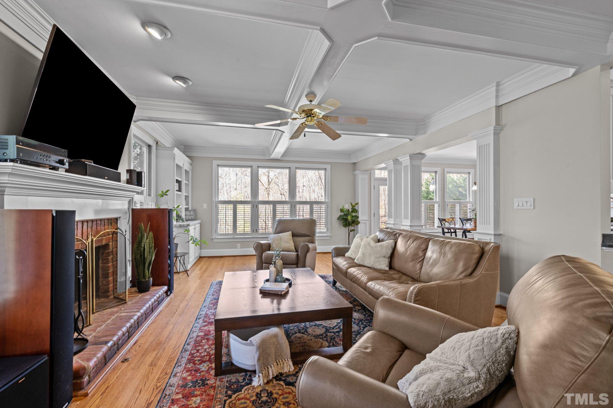 1112 Wagon Ridge Road Raleigh, NC 27614 - Photo 12 of 54 a living room with furniture a flat screen tv and a fireplace