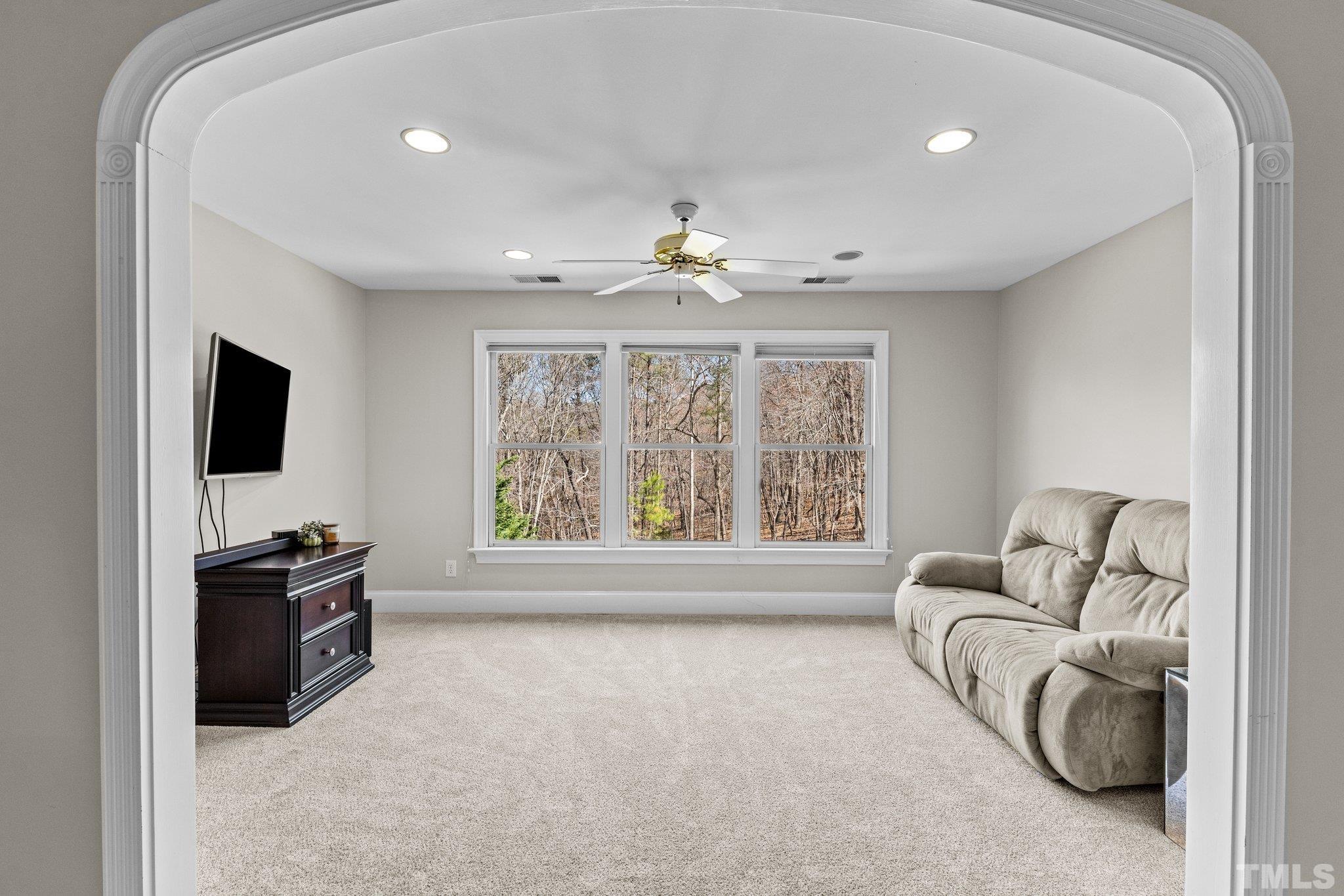 1112 Wagon Ridge Road Raleigh, NC 27614 - Photo 25 of 54 a living room with furniture a flat screen tv and a large window