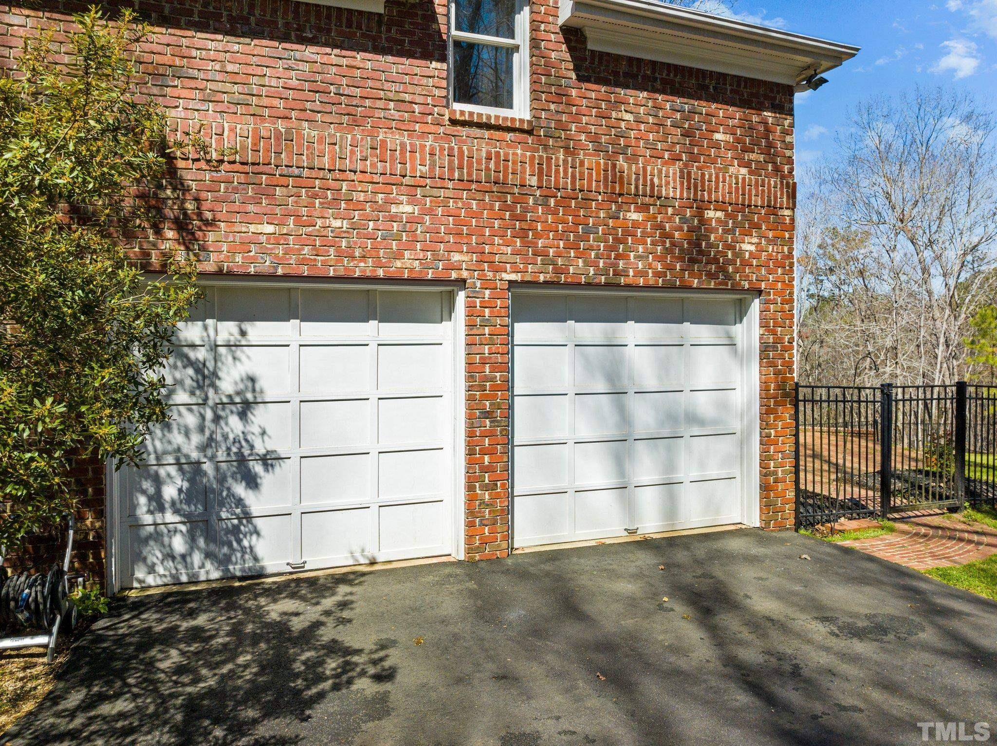 1112 Wagon Ridge Road Raleigh, NC 27614 - Photo 48 of 54 a front view of a house with a yard and garage