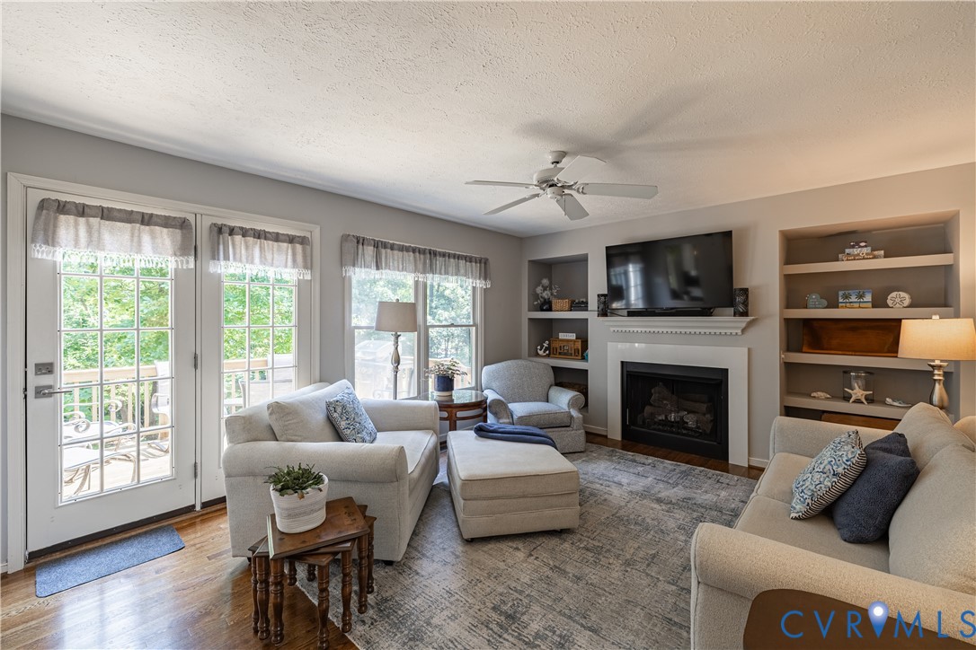 4501 Foxwood Road Chester, VA 23831 - Photo 15 of 42 Living area featuring wood-finish flooring, a fire