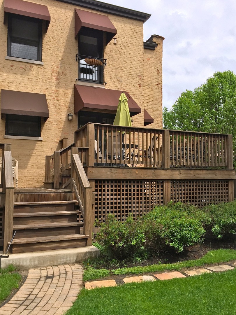 4722 North Malden Street Chicago, IL 60640 - Photo 28 of 42 a view of a brick house with a small yard