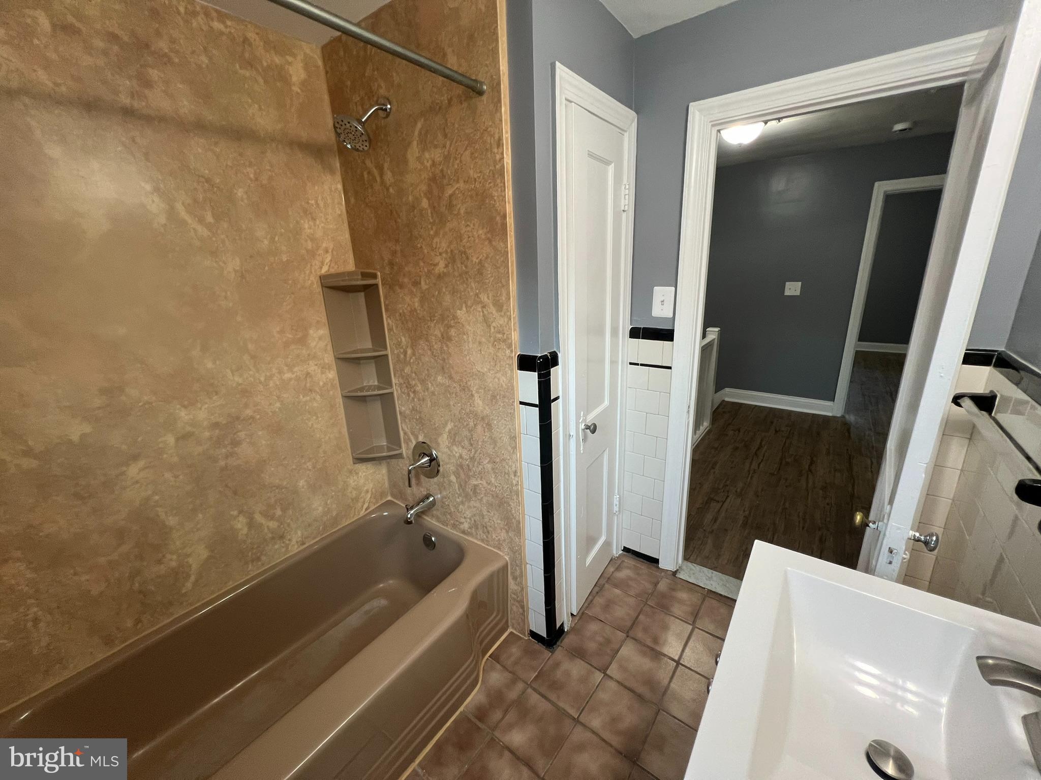 3925 Rexmere Road Baltimore, MD 21218 - Photo 17 of 25 a bathroom with a tub a sink and a shower