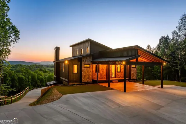 a view of a house with backyard wooden deck and sitting area