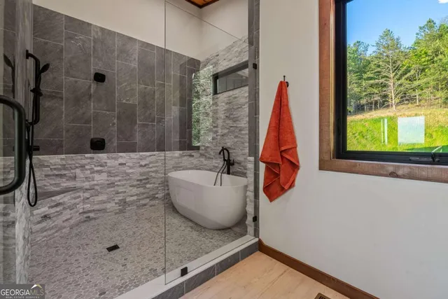 a bathroom with a granite countertop sink a toilet and shower