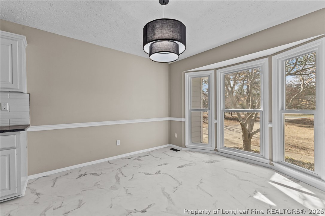 5356 Wade-Stedman Road Wade, NC 28395 - Photo 15 of 38 a view of an empty room with a window and kitchen view