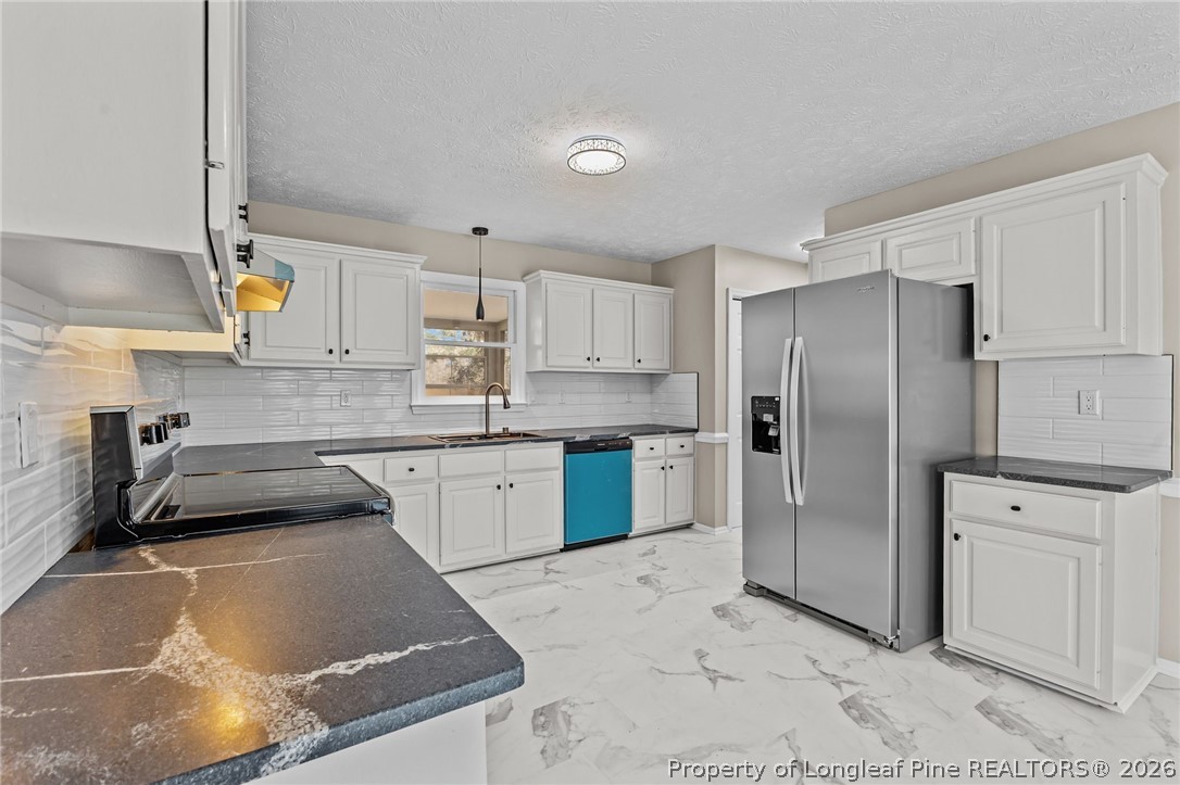 5356 Wade-Stedman Road Wade, NC 28395 - Photo 17 of 38 a kitchen with a refrigerator sink and cabinets
