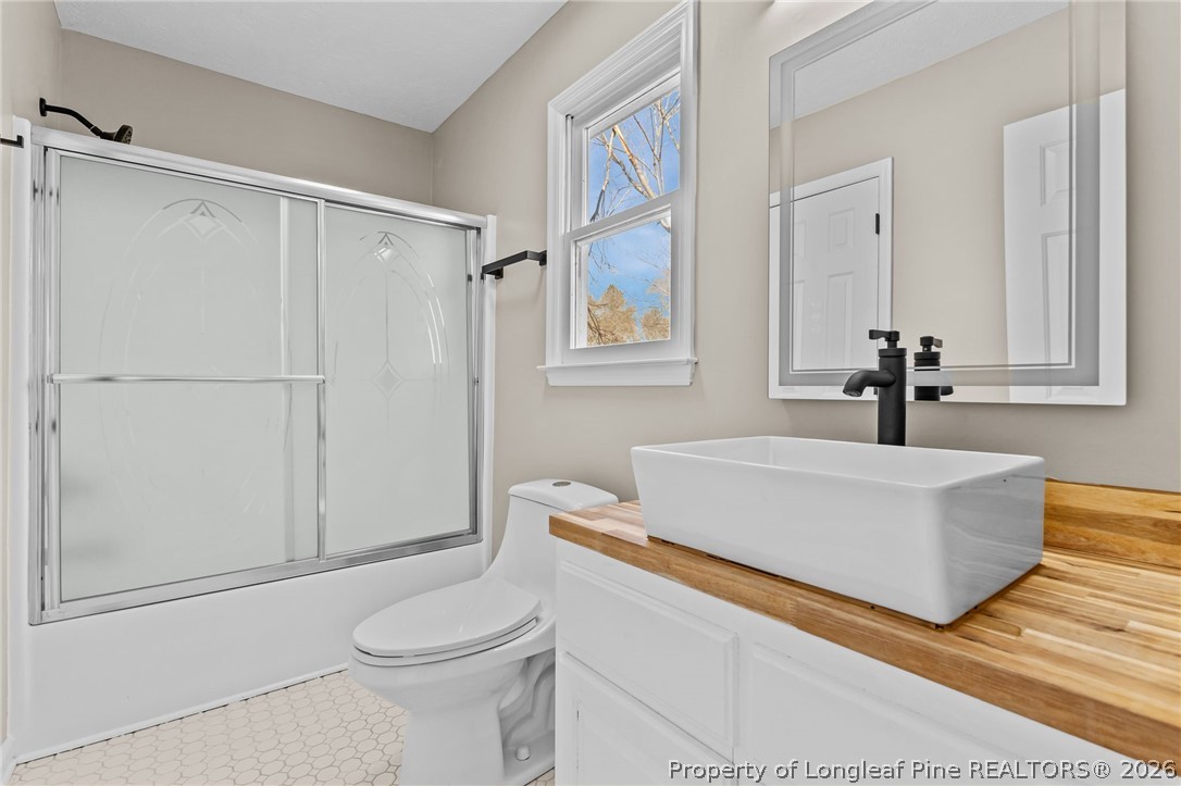 5356 Wade-Stedman Road Wade, NC 28395 - Photo 25 of 38 a bathroom with a sink a toilet and shower