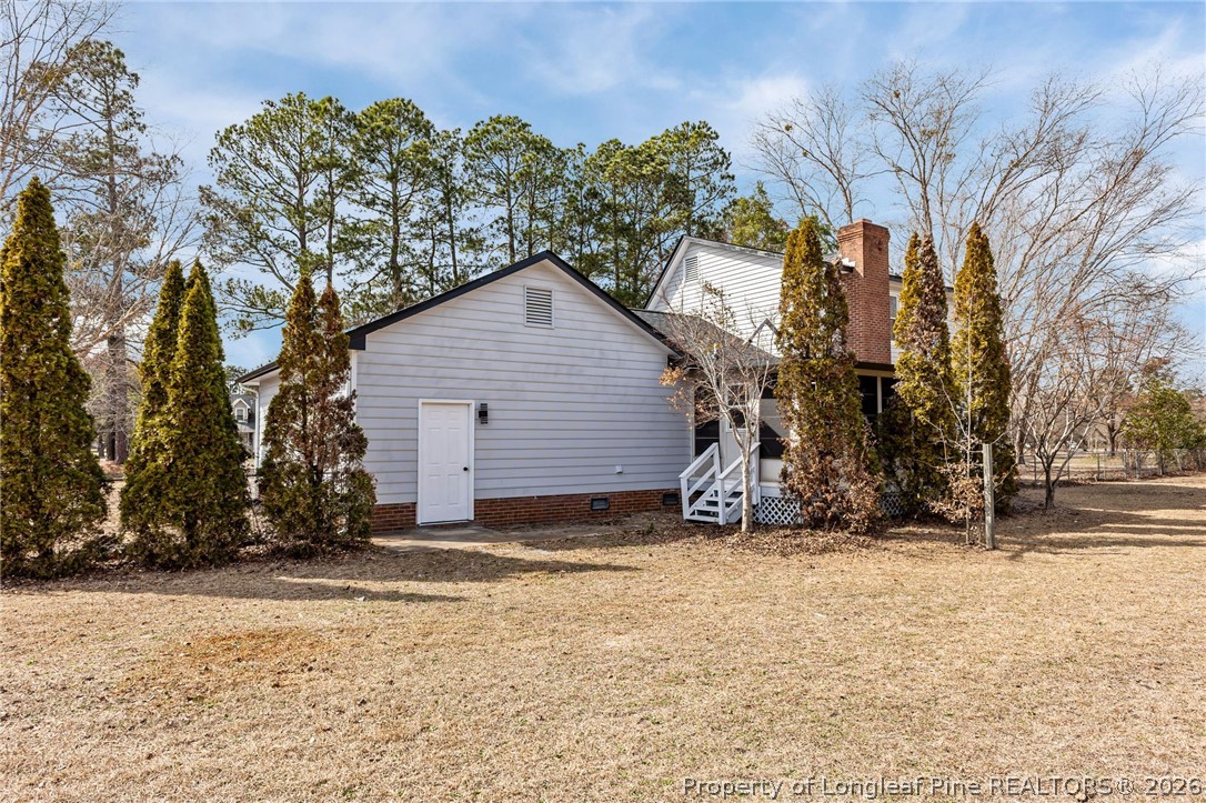 5356 Wade-Stedman Road Wade, NC 28395 - Photo 31 of 38 a view of wooden house with a yard covered with snow