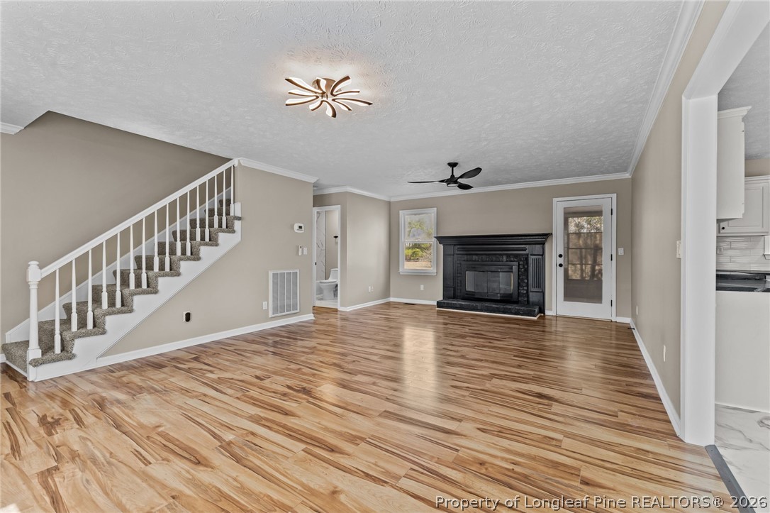 5356 Wade-Stedman Road Wade, NC 28395 - Photo 5 of 38 a view of an empty room with wooden floor fireplace and a window