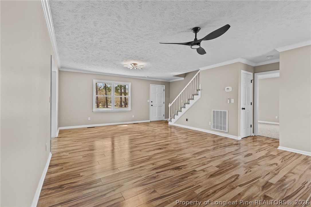 5356 Wade-Stedman Road Wade, NC 28395 - Photo 6 of 38 a view of empty room with wooden floor and fan