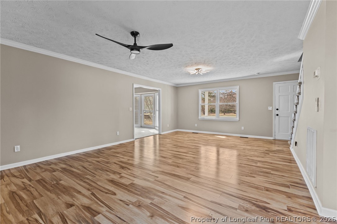 5356 Wade-Stedman Road Wade, NC 28395 - Photo 8 of 38 a view of empty room with wooden floor and fan