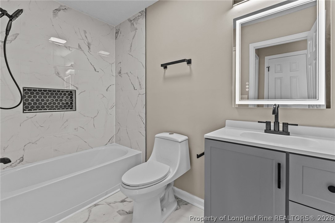 5356 Wade-Stedman Road Wade, NC 28395 - Photo 9 of 38 a bathroom with a sink a toilet and shower