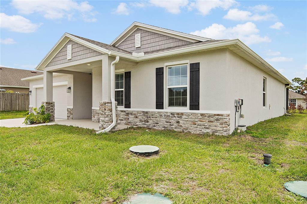 418 Fleming Street Sebastian, FL 32958 - Photo 34 of 38 a view of a house with a yard and sitting area