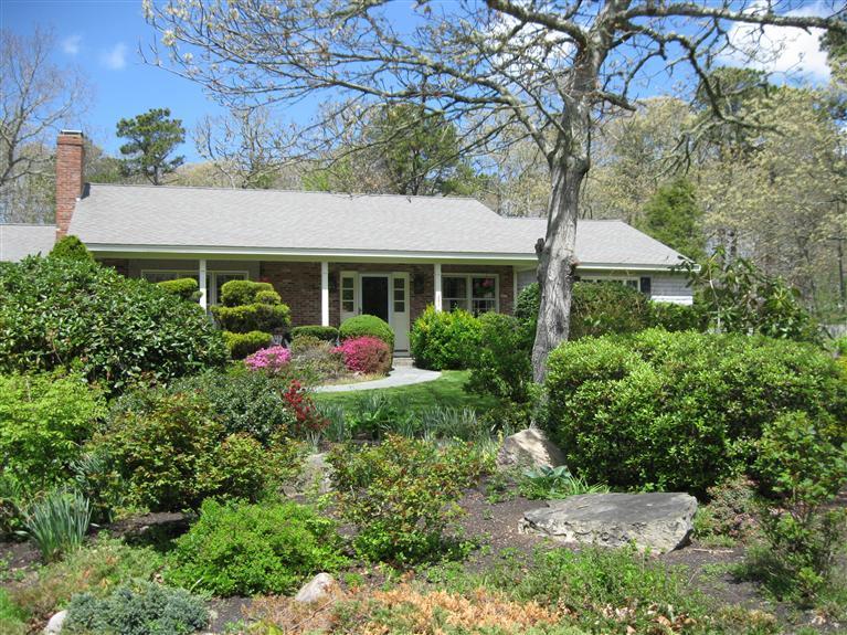 283 Round Cove Road Chatham, MA 02633 - Photo 2 of 24 a front view of a house with plants and trees