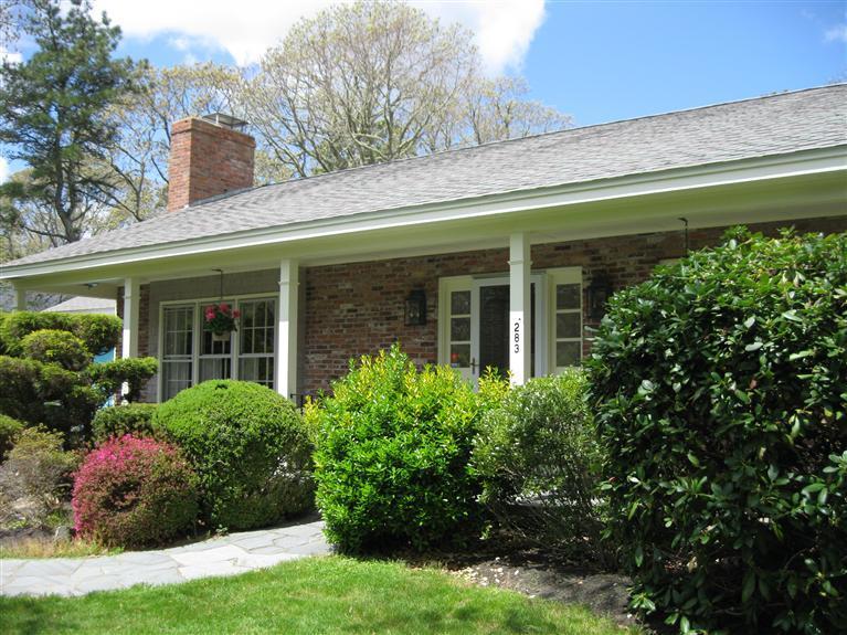 283 Round Cove Road Chatham, MA 02633 - Photo 3 of 24 a view of a house with potted plants and a table and chairs