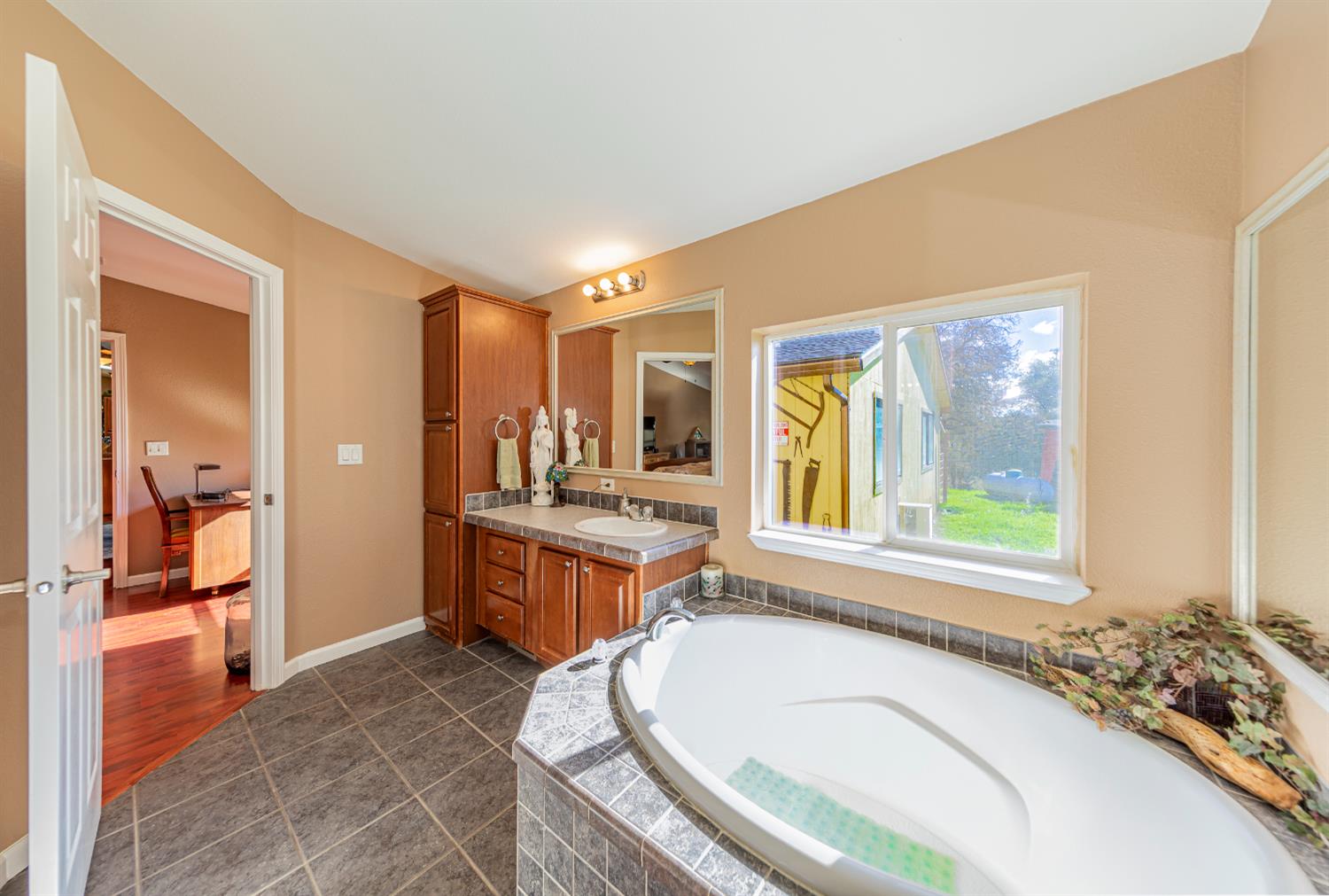 3335 Wildcat Road Mariposa, CA 95338 - Photo 30 of 48 a spacious bathroom with a granite countertop tub sink and mirror