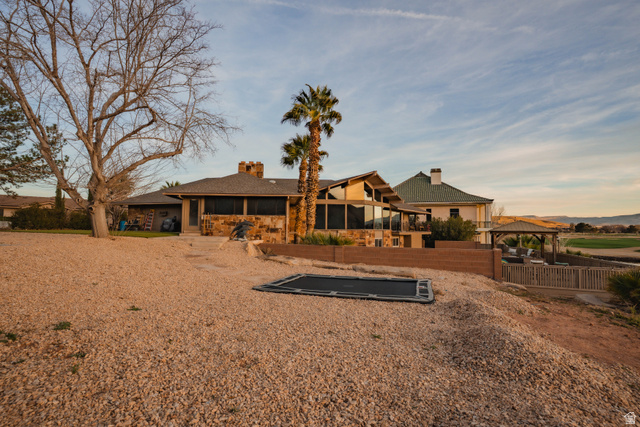 980 Cactus Circle St. George, UT 84790 - Photo 56 of 77 Back of property with a chimney, a patio, roof with shingles, and stone siding