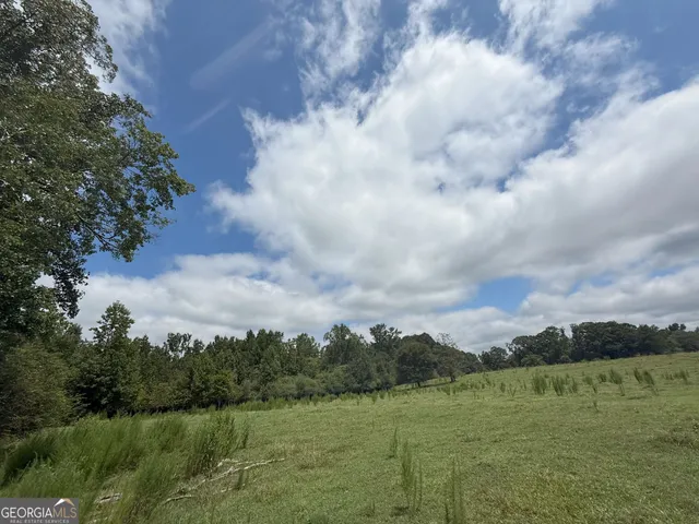 a view of a field with wooden fence