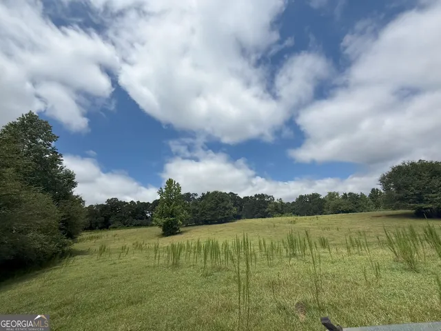 an aerial view of a house with a yard and lake view