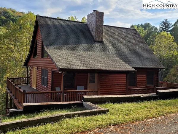 a view of a house with a wooden fence