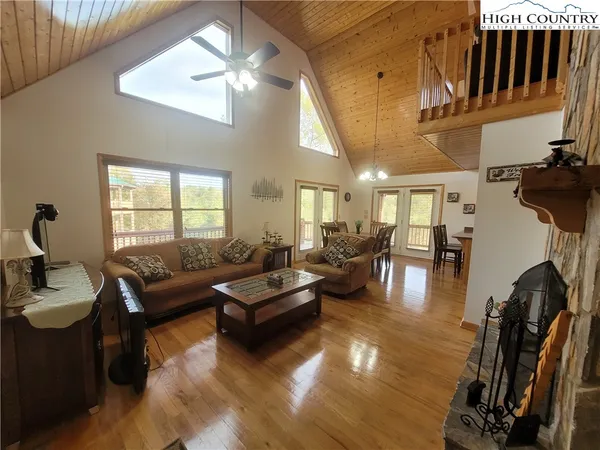 a living room with furniture a fireplace and a large window