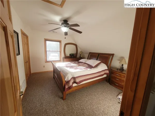 a bathroom with a double vanity sink a mirror and a toilet