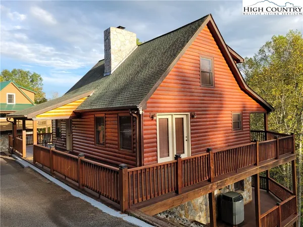 a view of a house with a wooden deck