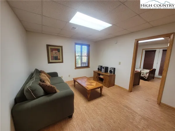 a living room with furniture window and wooden floor