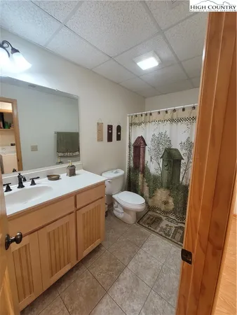 a bathroom with a double vanity sink toilet and shower
