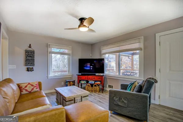 a kitchen with stainless steel appliances granite countertop a sink a stove a refrigerator cabinets and chairs